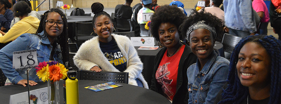 4 of 4, Group of students smiling at dinner table